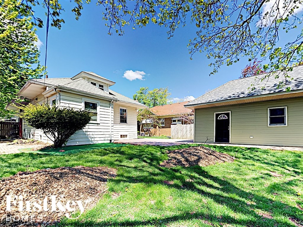 a white house with a yard in front of it