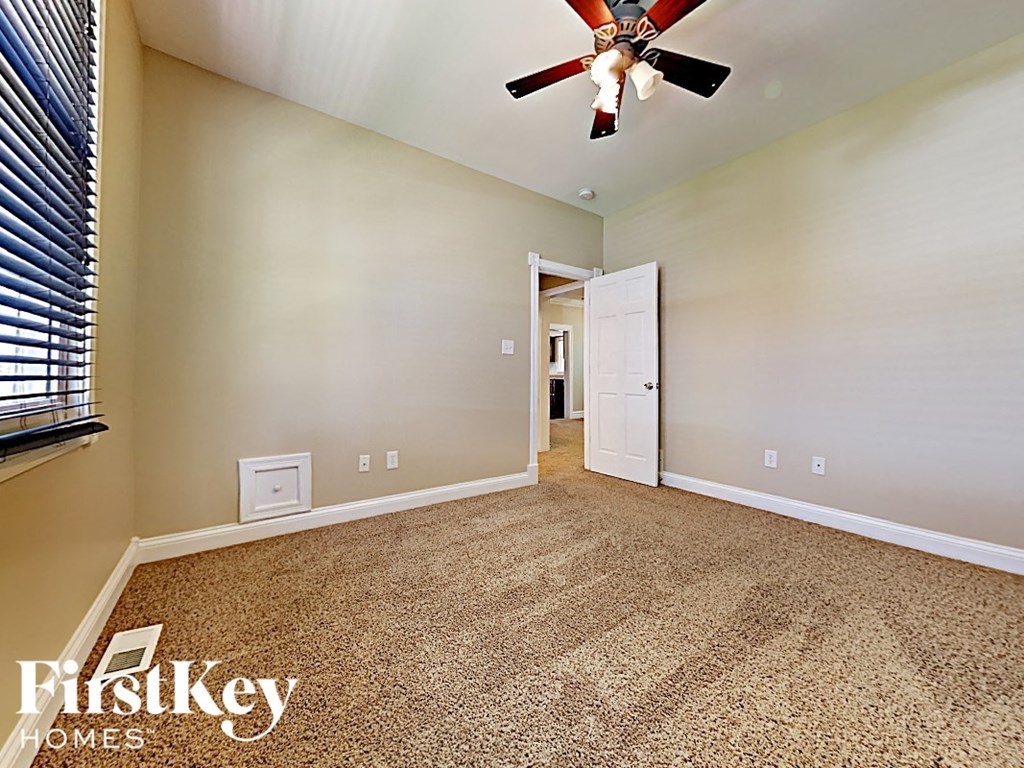 the master bedroom is spacious and has a ceiling fan