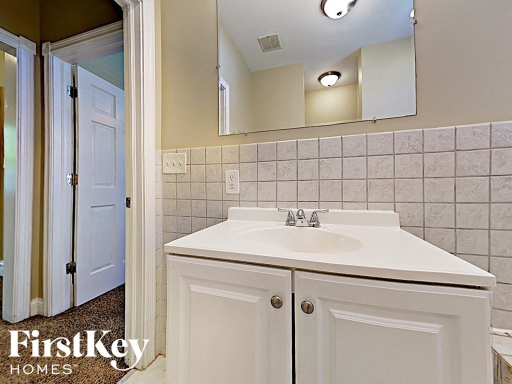 a bathroom with a sink and a mirror