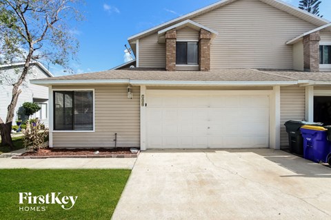 the front of a house with a white garage door
