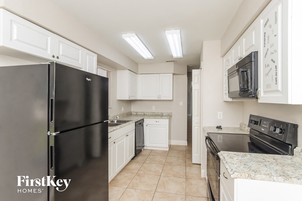 a kitchen with stainless steel appliances and white cabinets