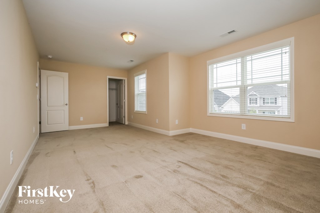 the living room of an empty house with a large window