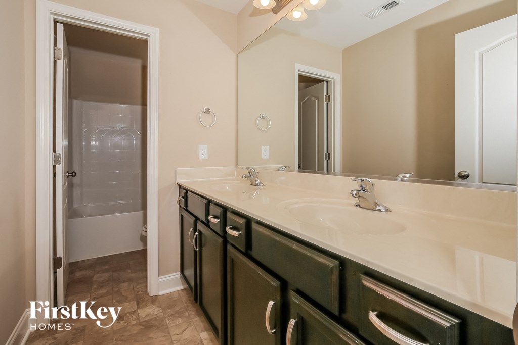 a bathroom with a sink and a mirror and a shower