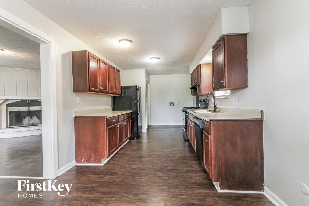 A kitchen with wooden cabinets and a white countertop.