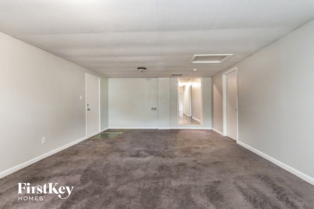 A room with a carpeted floor and white walls.