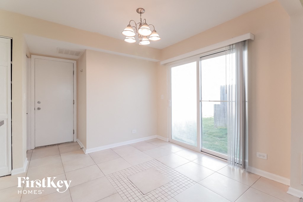 an empty living room with sliding glass doors to a balcony