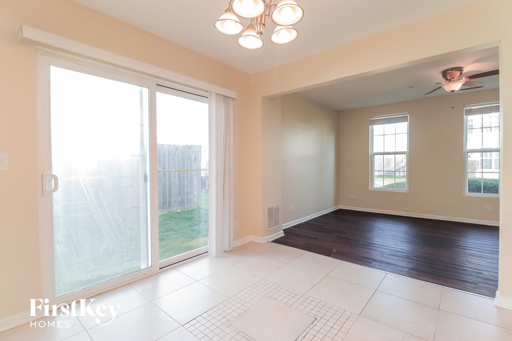 an empty living room with sliding glass doors to a patio