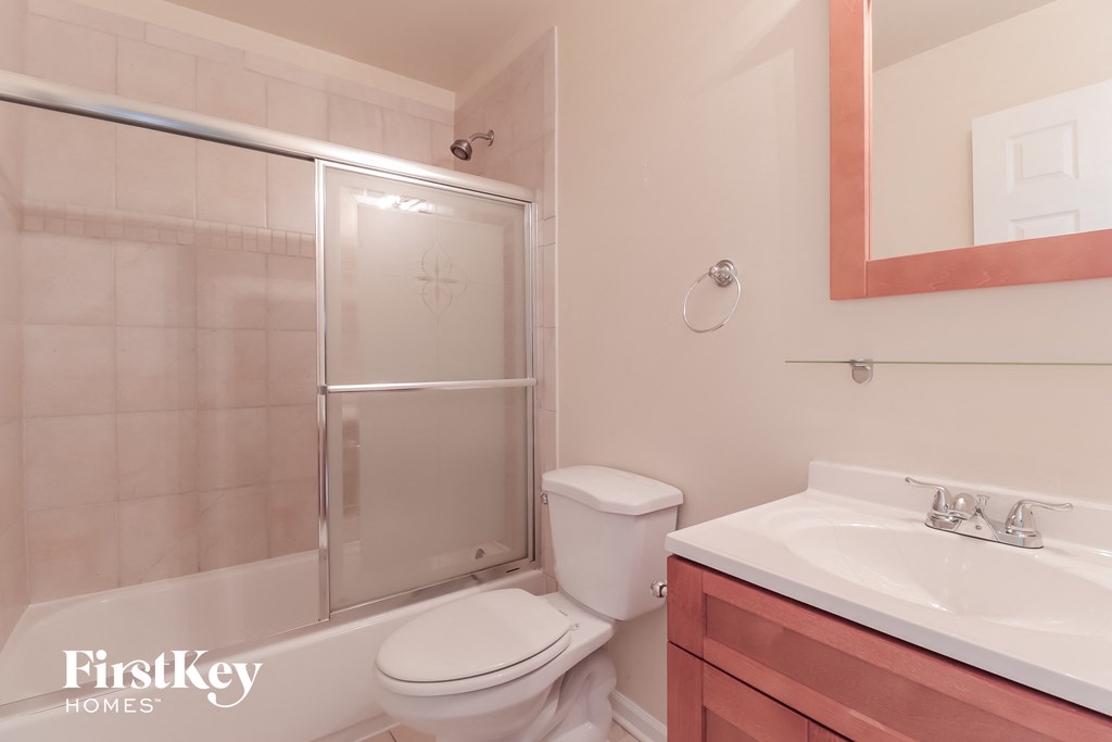a bathroom with a shower toilet and sink