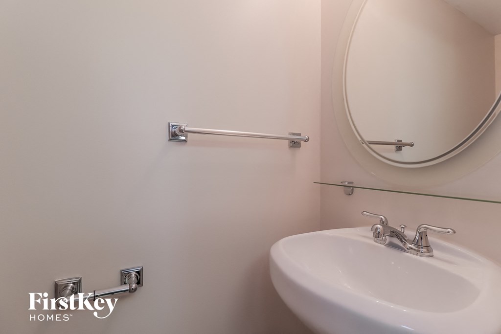 a small bathroom with a sink and a mirror