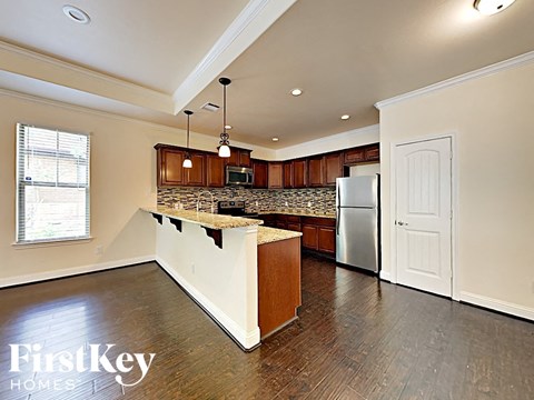 a kitchen with a counter top and a refrigerator