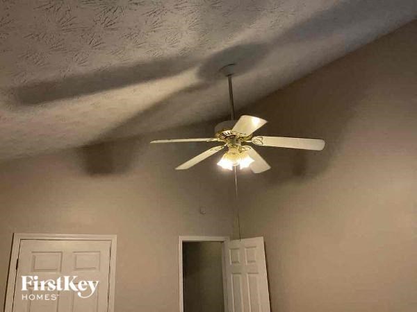 a ceiling fan with a light hanging from a ceiling