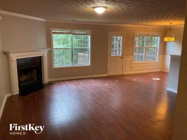 a living room with a fireplace and a wooden floor