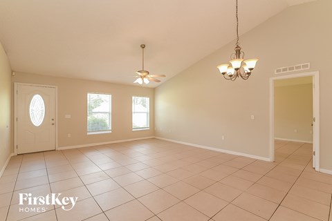 the living room and dining room are spacious and lighted by two ceiling fans