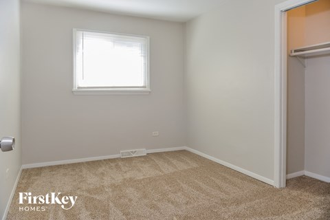 a bedroom with a closet and a window