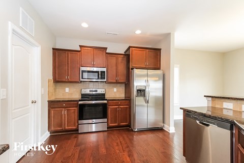 A kitchen with wooden cabinets and stainless steel appliances.