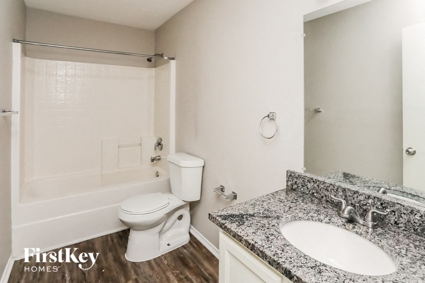 a bathroom with a toilet and a sink and a bath tub