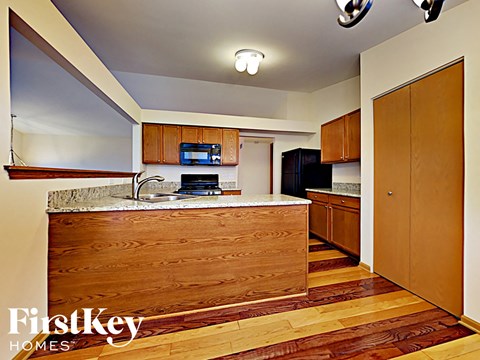 A kitchen with wooden cabinets and a counter top.