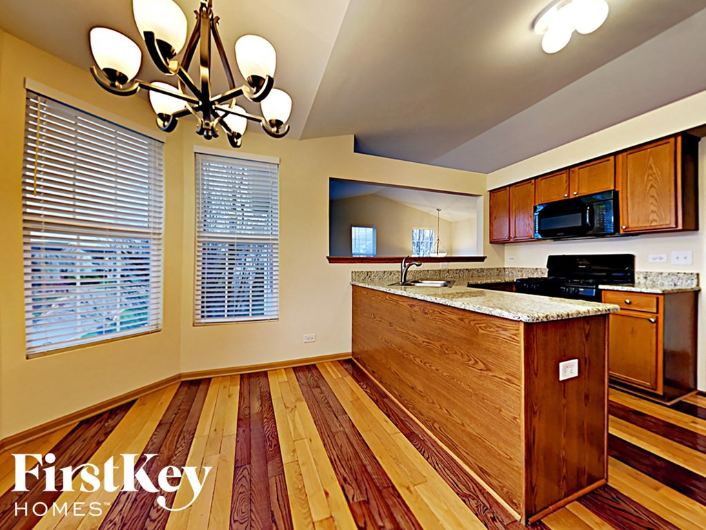 A kitchen with wooden floors and a wooden island.