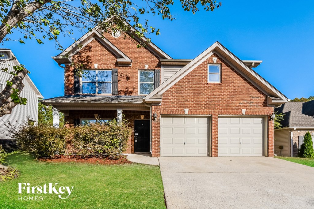 a large brick house with a white garage door