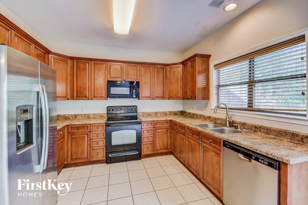 an updated kitchen with wood cabinets and granite counter tops