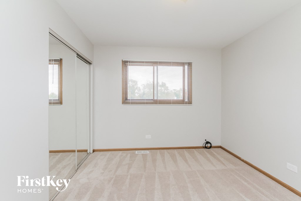 A room with a window and a bicycle on the floor.