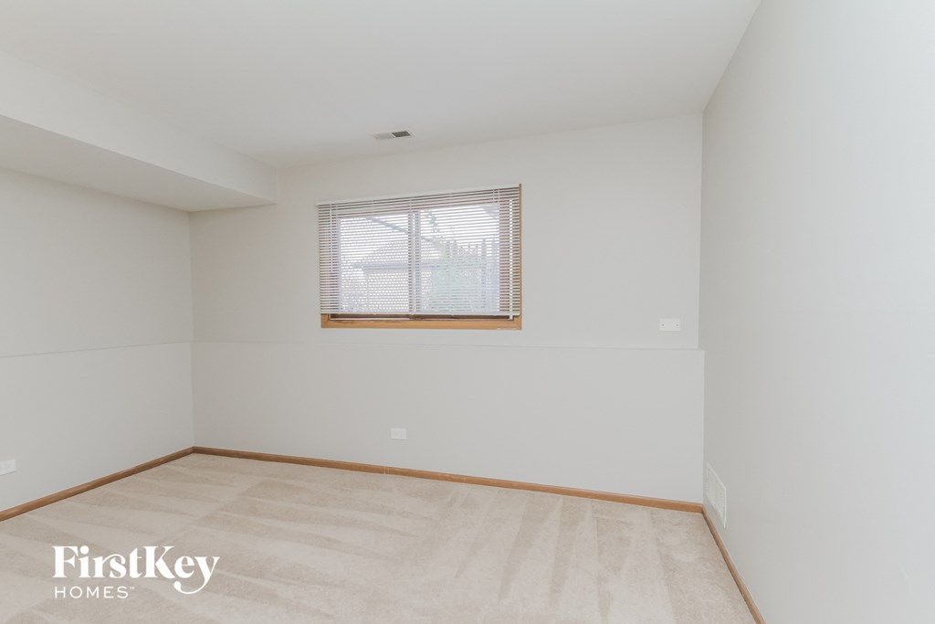 A room with a window and wooden flooring.