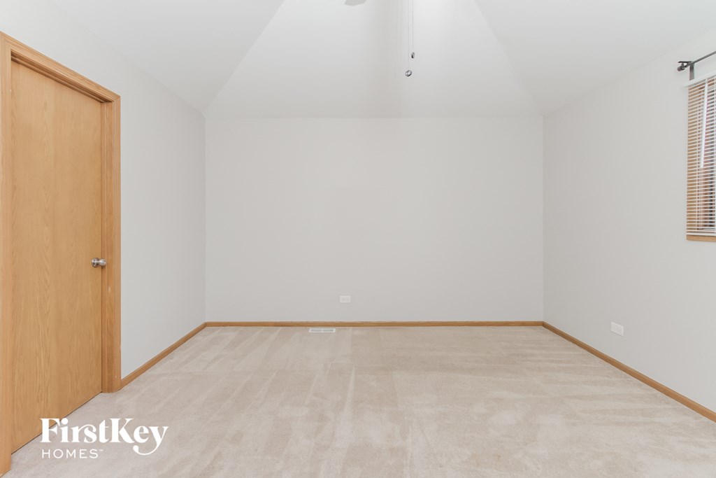 A room with a wooden door and a wooden floor.