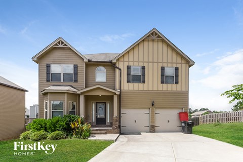 a tan and brown house with a white garage door