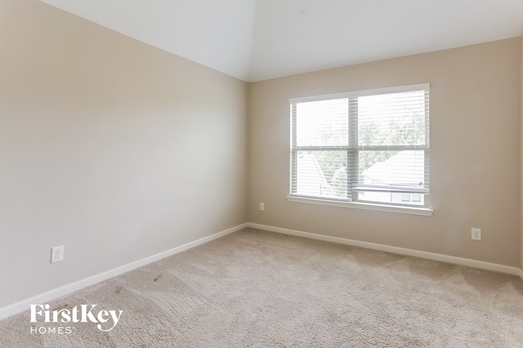 a room with carpet and a window in it