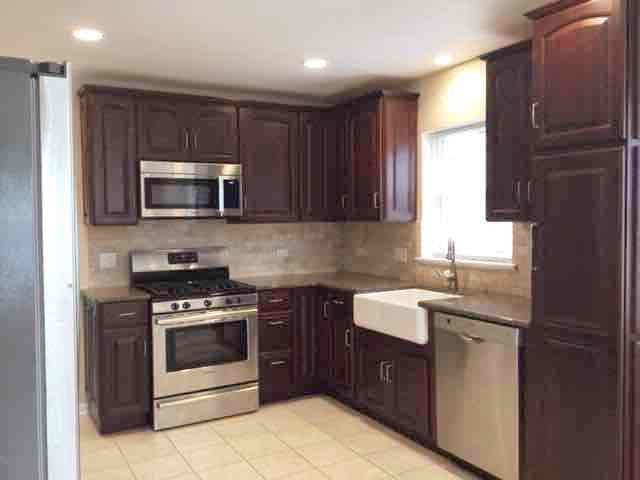 a kitchen with stainless steel appliances and dark cabinets
