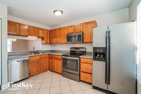 A kitchen with wooden cabinets and stainless steel appliances.