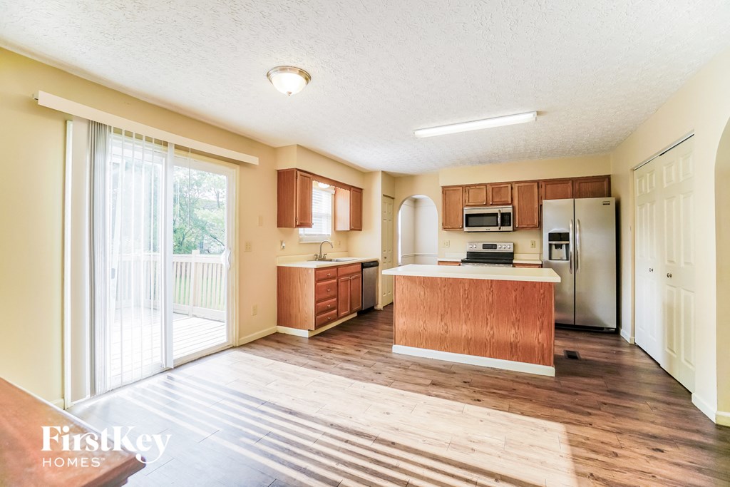 A kitchen with wooden floors and a wooden island.