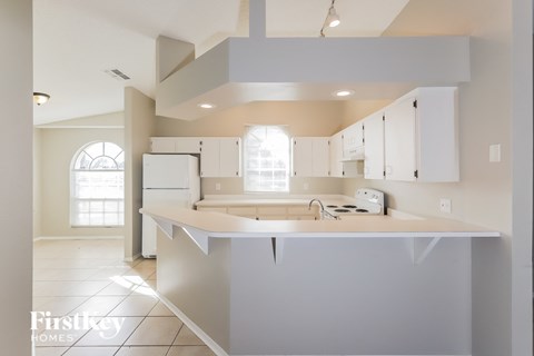 a kitchen with white cabinets and a white counter top