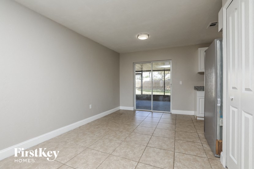 an empty living room with a door to a patio