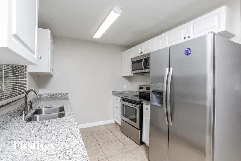 a kitchen with stainless steel appliances and granite counter tops