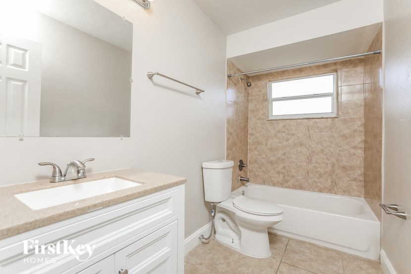 a bathroom with a toilet and a sink and a tub