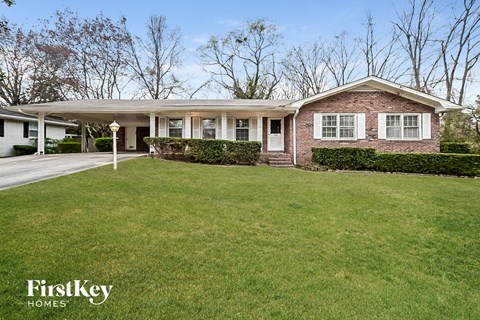 a brick house with a lawn in front of it