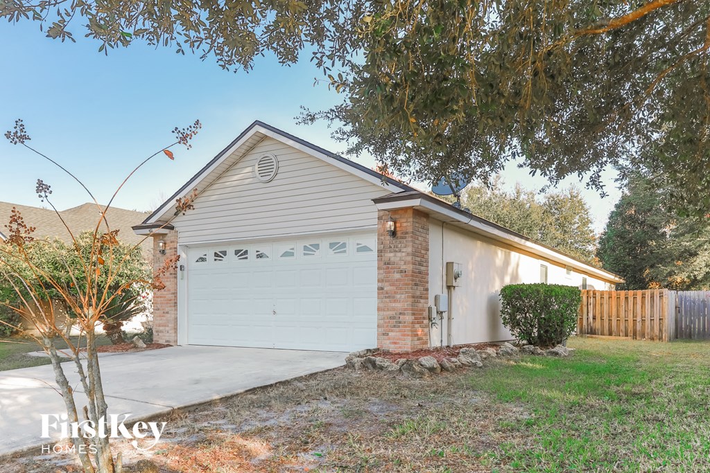 a white garage door in front of a white house