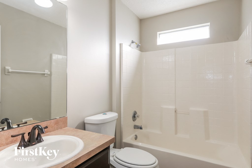 a bathroom with a shower and a sink and a toilet