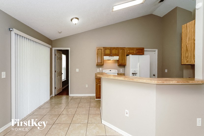 a kitchen with a counter top and a door to a hallway