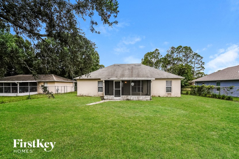 a house with a grassy yard and some trees