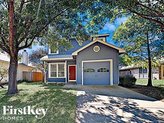a house with a garage and a tree