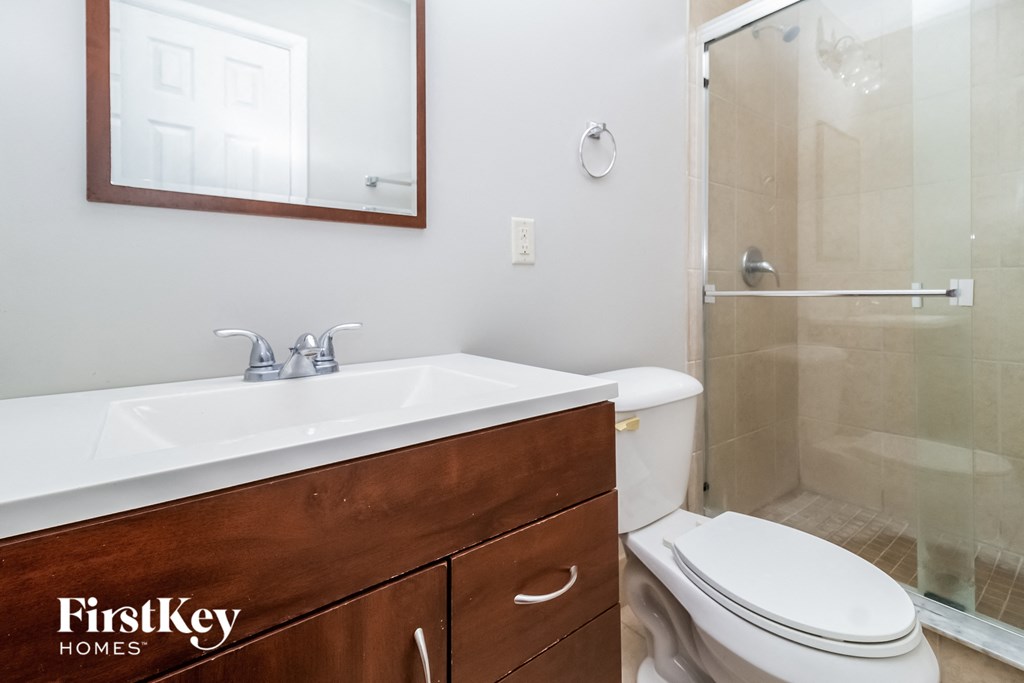 a bathroom with a toilet and a sink and a shower