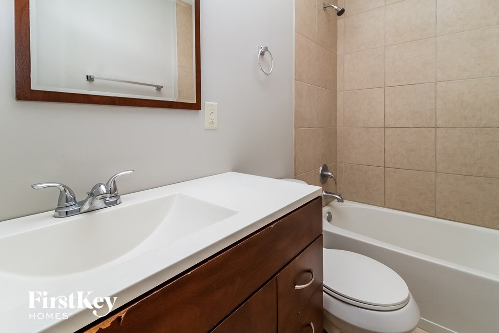 a bathroom with a sink and a toilet and a bath tub