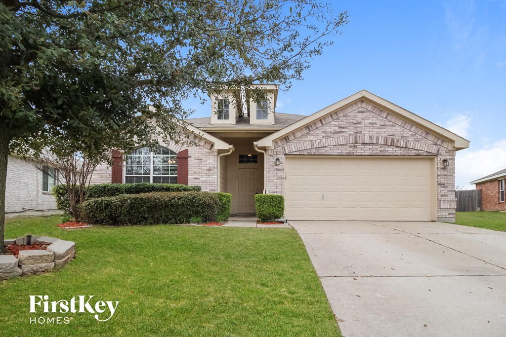 a white brick house with a garage and a driveway