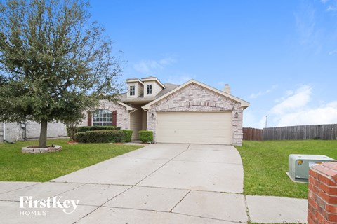 a white brick house with a white garage door
