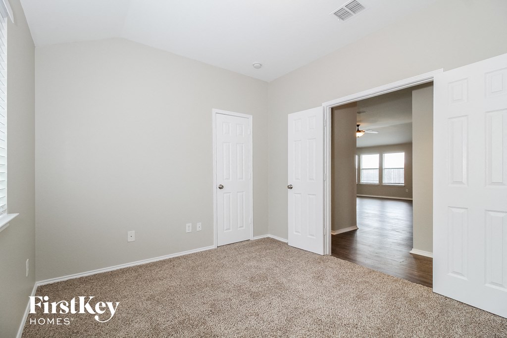 a bedroom with two closets and a door to a hallway