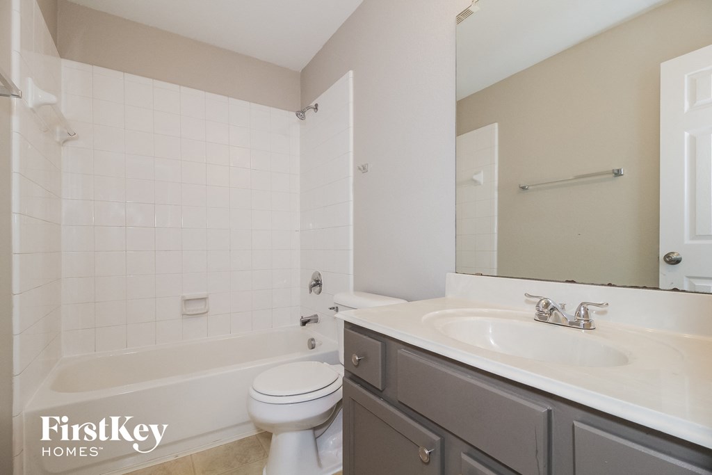 a bathroom with a sink and a toilet and a tub