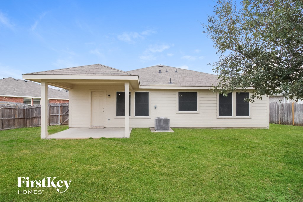 a small white house with a yard and a porch
