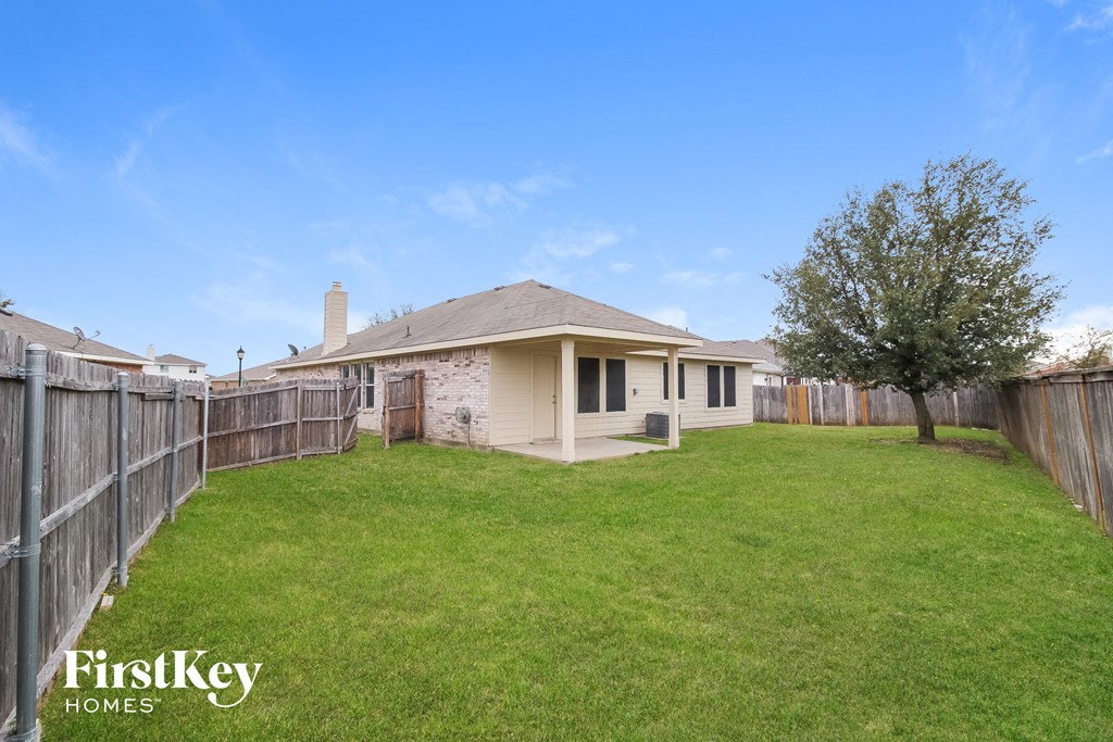 a backyard with a fence and a house